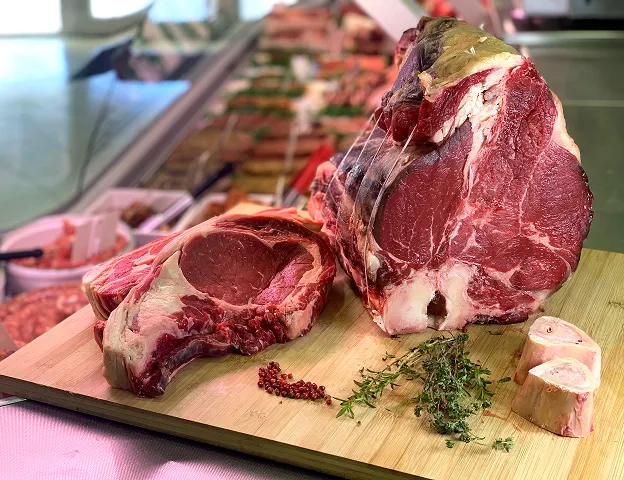 Bœuf cru et côte de bœuf sur planche en bois avec herbes et os Le Passage près d'Agen dans le Lot-et-Garonne 47